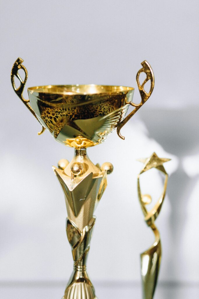 Close-up of golden trophies showcasing elegance and achievement in a well-lit setting.